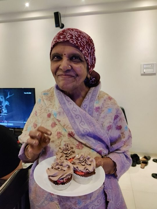 Kalpana with her granddaughter Kyna who brought her a cupcake