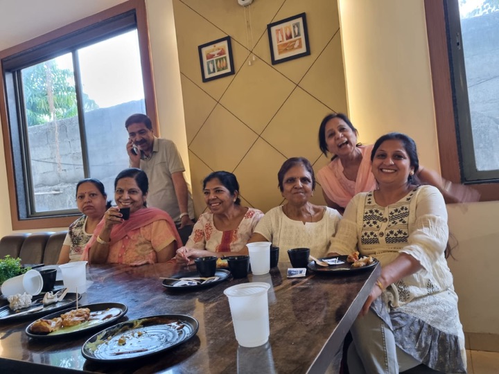 A family lunch around a marble table with chai and snacks