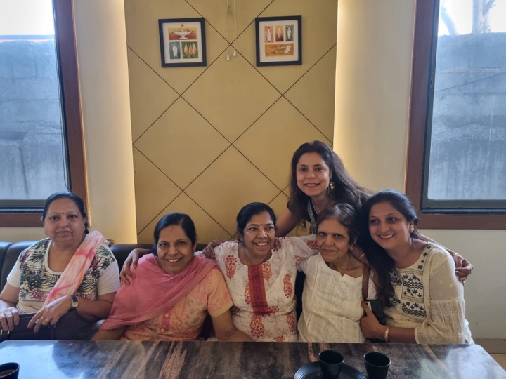 A posed group portrait of family women, arms around each other